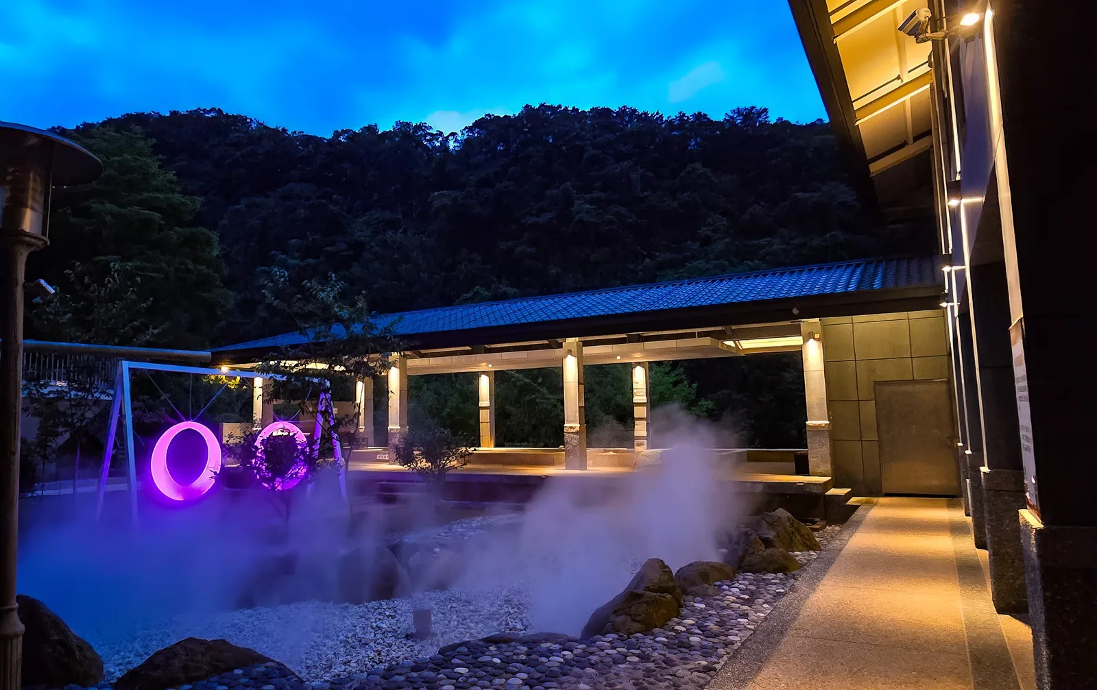 夜間發光鞦韆與旁邊冒著蒸氣的湯池